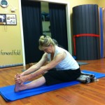 Randy in a seated forward fold (Padangushthasana)